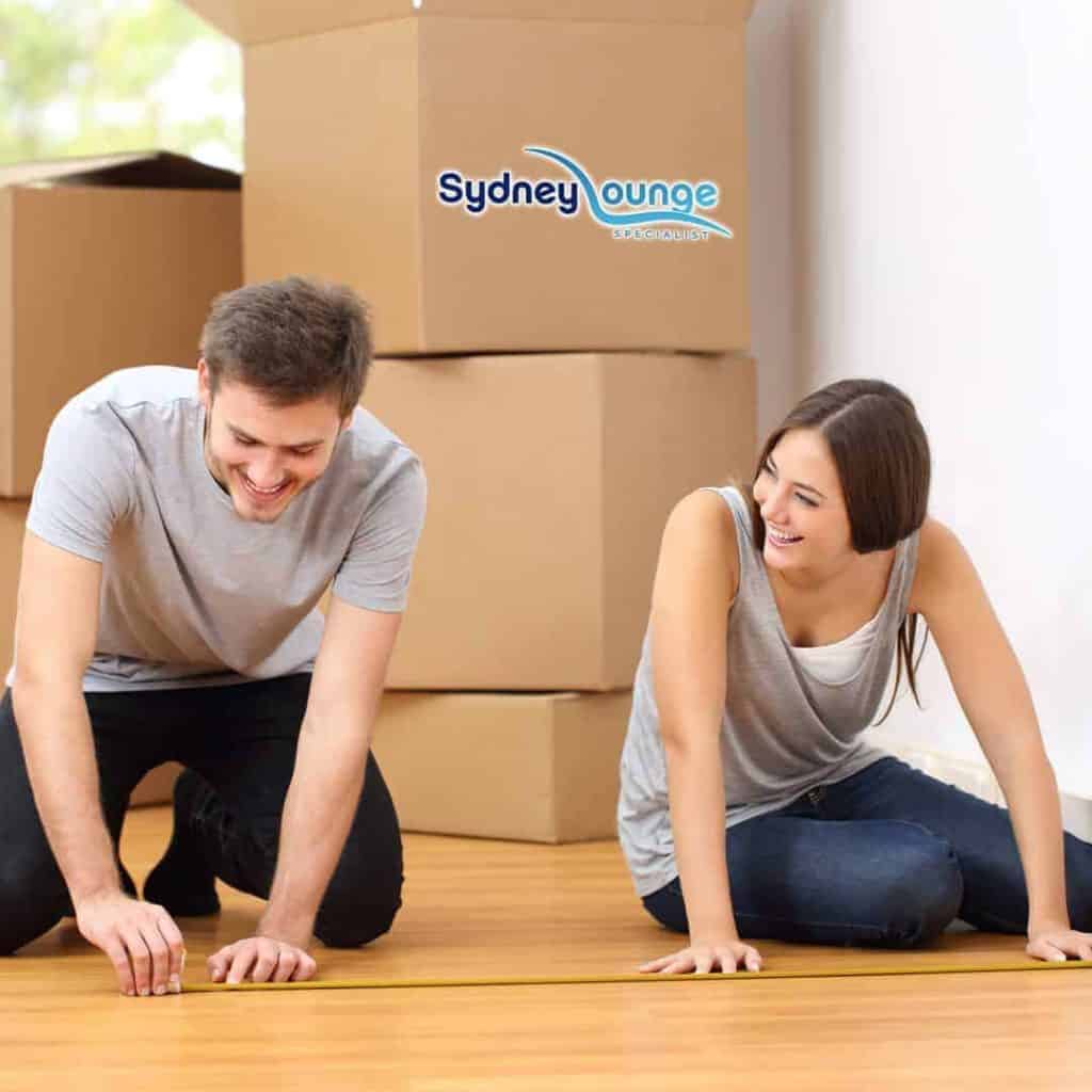 Couple moving home and packing boxes, Sydney Lounge Specialist logo